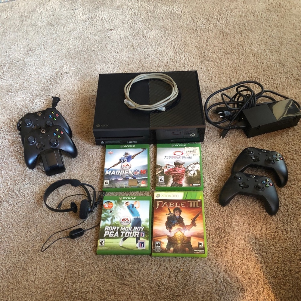 Xbox One with controllers and games.